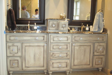 Inspiration for a mid-sized eclectic master bathroom remodel in Minneapolis with raised-panel cabinets, distressed cabinets and granite countertops