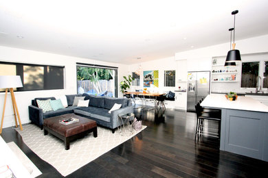 Inspiration for a mid-sized contemporary open concept dark wood floor living room remodel in Los Angeles with white walls, a standard fireplace, a stone fireplace and a media wall
