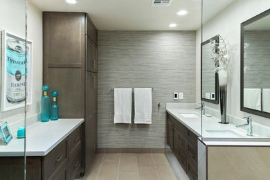Design ideas for a mid-sized transitional master bathroom in Phoenix with shaker cabinets, grey cabinets, a corner shower, a one-piece toilet, white tile, porcelain tile, grey walls, porcelain floors, an undermount sink, engineered quartz benchtops, grey floor, an open shower and white benchtops.