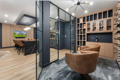 Example of a large minimalist vinyl floor and beige floor basement design in DC Metro with a bar and blue walls