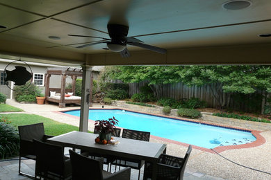 Photo of a modern backyard patio in Dallas with a roof extension.