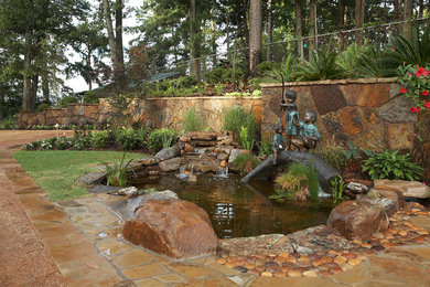 Design ideas for a small mediterranean backyard stone pond in New Orleans for summer.