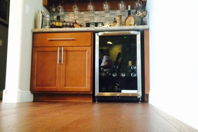 Photo of a modern home bar in Phoenix with medium hardwood floors.