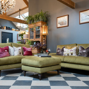 Lounge area with The Louge Co. green sofas with black and white tiles.