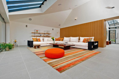Living room - large eclectic open concept living room idea in New York with white walls