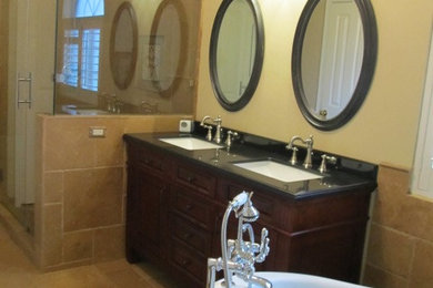 Inspiration for a timeless brown tile and stone tile travertine floor bathroom remodel in Austin with an undermount sink, granite countertops and beige walls