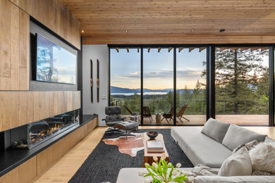 Inspiration for a large contemporary formal and open concept light wood floor, wood ceiling and wood wall living room remodel in Boise with white walls, a ribbon fireplace, a wood fireplace surround and a media wall