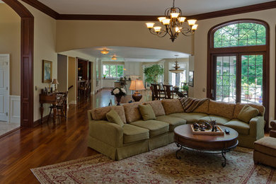 Example of a mid-sized classic open concept medium tone wood floor family room design in Other with white walls, a standard fireplace, a tile fireplace and a tv stand