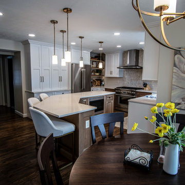 Two Tone Kitchen with Floating Shelves and Island Seating and Updated Fireplace