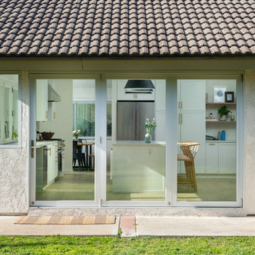 AG BiFold Patio Door & Window Pairing Connects All-White Kitchen to the Outdoors