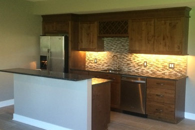 Inspiration for a small transitional single-wall porcelain tile wet bar remodel in Other with an undermount sink, shaker cabinets, dark wood cabinets, granite countertops, beige backsplash and mosaic tile backsplash