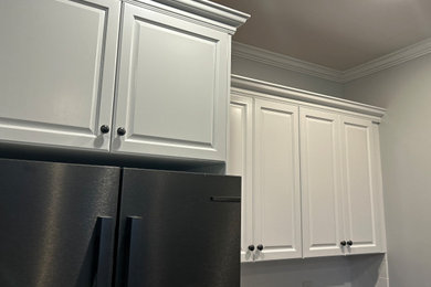 Kitchen - mid-sized kitchen idea in Atlanta with white cabinets