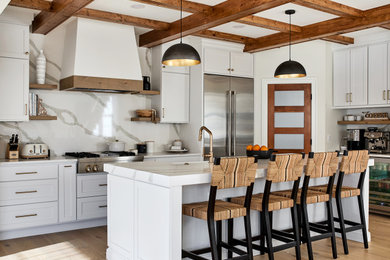 Eat-in kitchen - large country light wood floor eat-in kitchen idea in DC Metro with white cabinets, white backsplash, stainless steel appliances, two islands and white countertops