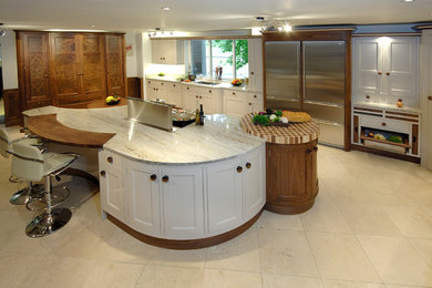 Photo of a traditional kitchen/diner in Other with shaker cabinets, marble worktops, stainless steel appliances, porcelain flooring, an island and beige floors.