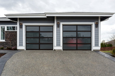 This is an example of a mid-sized modern attached two-car garage in Seattle.