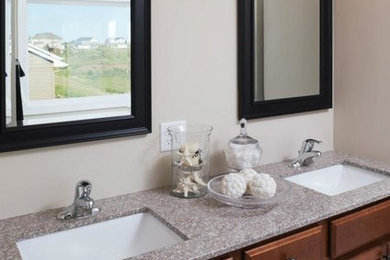 Mid-sized master bathroom photo in Minneapolis with a drop-in sink, raised-panel cabinets, medium tone wood cabinets, granite countertops and beige walls