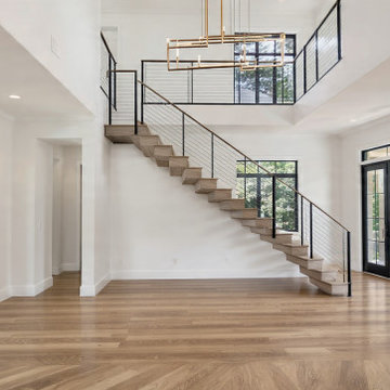 High-Ceiling Modern Entryway & Floating Staircase in Highland Park