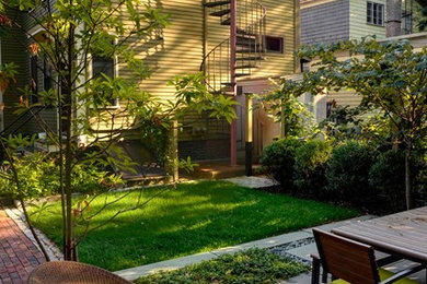 Example of a mid-sized classic backyard stone patio design in Boston