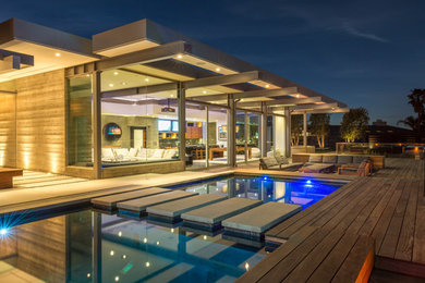 Inspiration for a large modern backyard patio remodel in Los Angeles with decking