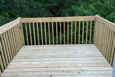 Backyard second story wood railing deck photo in Raleigh with no cover