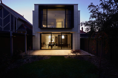 Design ideas for a large modern two-storey exterior in Melbourne with wood siding and a flat roof.