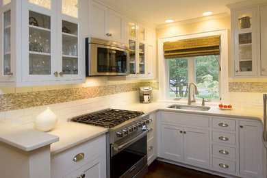 Example of a small transitional u-shaped dark wood floor and brown floor eat-in kitchen design in Raleigh with an undermount sink, recessed-panel cabinets, white cabinets, quartz countertops, white backsplash, subway tile backsplash, stainless steel appliances, no island and beige countertops