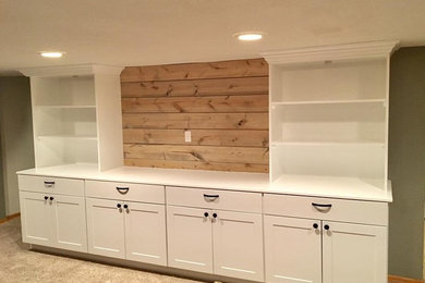 Basement Remodel with custom media center, dry bar, and distressed wood tables