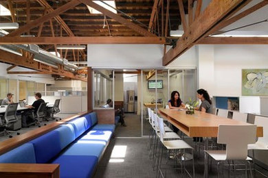 Example of a huge minimalist built-in desk carpeted home studio design in Los Angeles with white walls