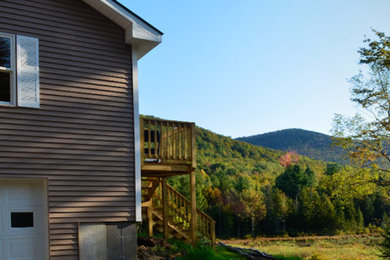 Inspiration for a mid-sized gray two-story mixed siding exterior home remodel in Burlington with a hip roof