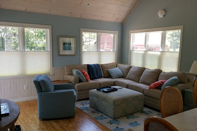 Family room - large coastal open concept medium tone wood floor and brown floor family room idea in Boston with blue walls and no fireplace