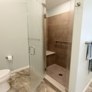 Warm Gray Vanity with Maple Truffle Accent Linen Cabinet and Tiled Shower