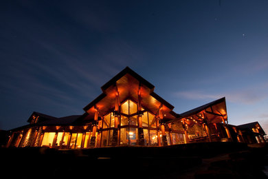 Example of a large mountain style one-story stone exterior home design in Austin
