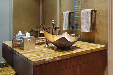 Inspiration for a small contemporary 3/4 multicolored tile and stone slab marble floor alcove shower remodel in Miami with furniture-like cabinets, medium tone wood cabinets, a one-piece toilet, beige walls, a vessel sink and onyx countertops