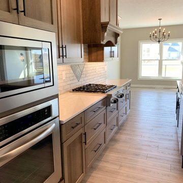 New Home With Warm-Stained Hickory Kitchen and Stylish Bathroom Tile