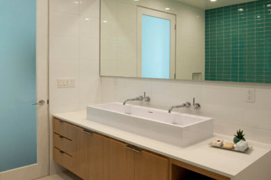 Mid-sized transitional master blue tile and glass tile ceramic tile, white floor and double-sink bathroom photo in Los Angeles with flat-panel cabinets, white walls, a vessel sink, solid surface countertops, white countertops and a floating vanity