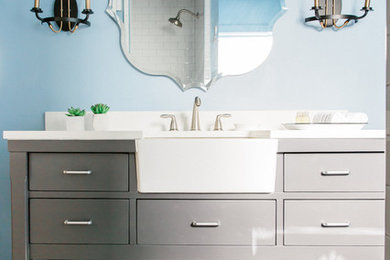 Mid-sized farmhouse ceramic tile and multicolored floor bathroom photo in Austin with furniture-like cabinets, gray cabinets, blue walls, solid surface countertops and white countertops