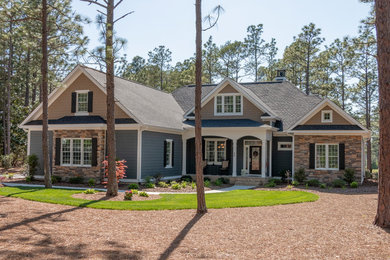 Large arts and crafts multicolored two-story mixed siding exterior home photo in Raleigh with a shingle roof