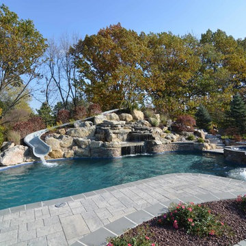 Custom Freeform style salt water in ground pool with Waterslide and Spa