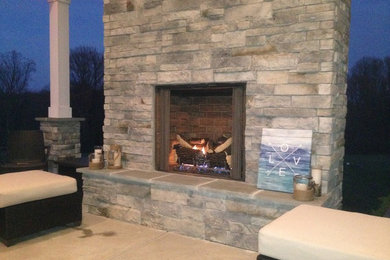Patio - mid-sized backyard concrete patio idea in Baltimore with a fire pit