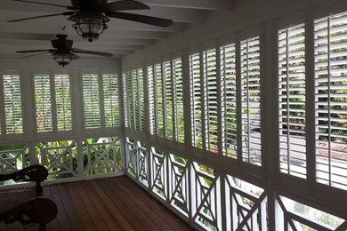 This is an example of a mid-sized tropical back porch design in San Diego.