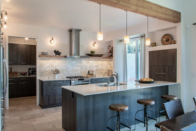 Inspiration for a large contemporary u-shaped travertine floor kitchen remodel in Seattle with an undermount sink, flat-panel cabinets, dark wood cabinets, quartz countertops, white backsplash, marble backsplash, stainless steel appliances and an island