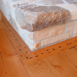 Reclaimed Douglas Fir Flooring Beside a Stone Fireplace Hearth - Hardwood Flooring
