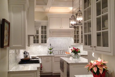 Kitchen - large transitional l-shaped dark wood floor kitchen idea in Charleston with a farmhouse sink, beaded inset cabinets, white cabinets, marble countertops, white backsplash, subway tile backsplash, white appliances and an island