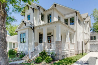 Large traditional white two-story house exterior idea in Houston with a shingle roof