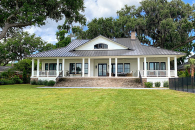 Example of a mid-sized transitional white one-story concrete fiberboard exterior home design in Jacksonville with a metal roof