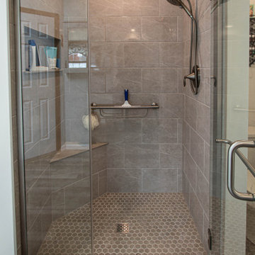Waypoint Gray Shaker Door Cabinetry with Tiled Shower and Matching Tub Surround