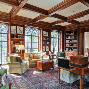 Large traditional study room in Dallas with brown walls, medium hardwood floors, a standard fireplace, a tile fireplace surround, a freestanding desk and brown floor.