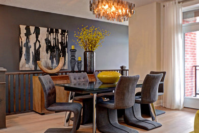 Example of a mid-sized trendy medium tone wood floor and brown floor great room design in Toronto with gray walls and no fireplace