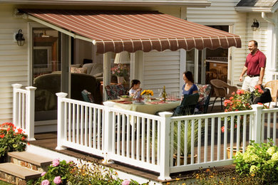 Elegant patio photo in Other with an awning