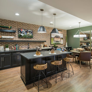 This is an example of a traditional basement in Philadelphia with green walls, medium hardwood flooring and brown floors.